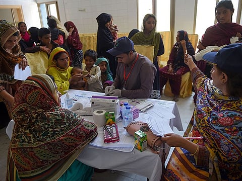 Pakistani paramedics take blood samples from children for HIV tests at a state-run hospital in Rato Dero in the district of Larkana of the southern Sindh province.