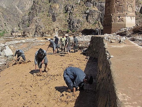 Afghan men working at a site near the Minaret of Jam following floodwaters in the Shahrak District of Ghor Province.