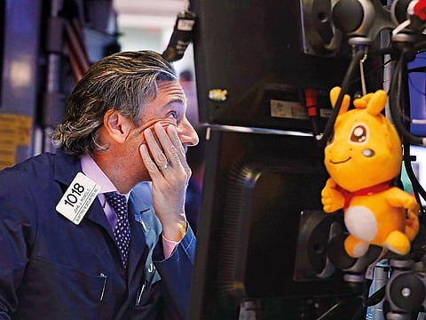 A trader works on the floor of the New York Stock Exchange.