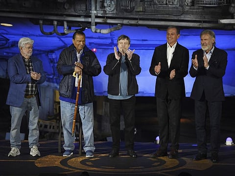 From left: "Star Wars" franchise creator George Lucas, cast members Billy Dee Williams and Mark Hamill, Walt Disney Co. Chairman and CEO Bob Iger and cast member Harrison Ford applaud onstage at a dedication ceremony in front of the Millennium Falcon during the Star Wars: Galaxy's Edge Media Preview at Disneyland Park.
