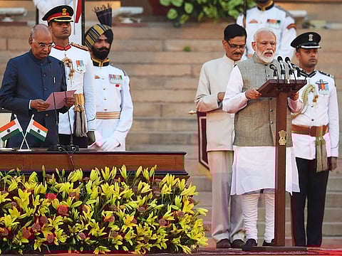 Narendra Modi (right) takes the oath of office as India's Prime Minister at the President house in New Delhi on May 30, 2019.