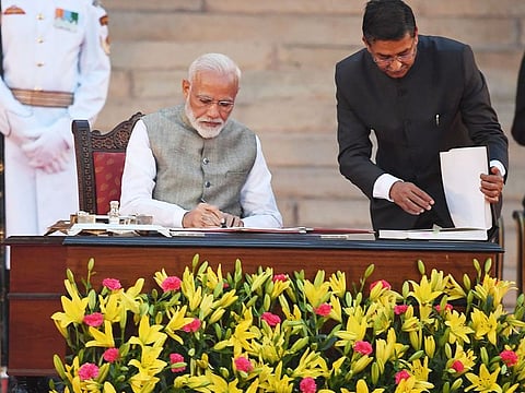 Narendra Modi signs documents after taking the oath of office as India's Prime Minister at the President house in New Delhi on May 30, 2019.