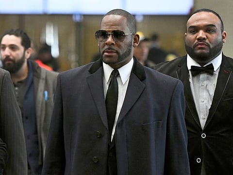 Musician R. Kelly, center, arrives at the Leighton Criminal Court building for a hearing in Chicago earlier in May.