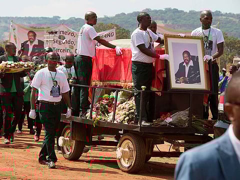 Pallbearers guard the coffin of Jonas Savimbi, a former leader of the UNITA movement, as it is carried during the reburial of the remains on June 1, 2019, in his home village of Lopitanga, near the town of Andulo, in Bie Province in Angola.