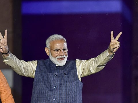 New Delhi: Prime Minister Narendra Modi flashes the victory sign as he arrives at the party headquarters to celebrate the party's victory in the 2019 Lok Sabha elections, in New Delhi, Thursday, May 23, 2019. (PTI Photo/Ravi Choudhary) (PTI5_23_2019_000464B)