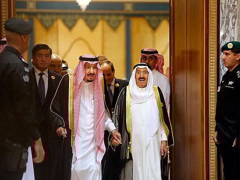 Saudi King Salman, center left, is accompanied by Kuwait's Emir Sheikh Sabah al-Ahmad al-Jaber al-Sabah, center right, as they enter the Islamic Summit of the Organization of Islamic Cooperation (OIC) in Mekkah, Saudi Arabia, early Saturday, June 1, 2019.