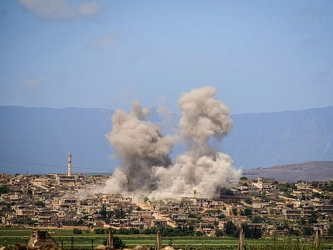 In this  file photo, smoke rises after Syrian regime and Russian air strikes in a town in southern Idlib.