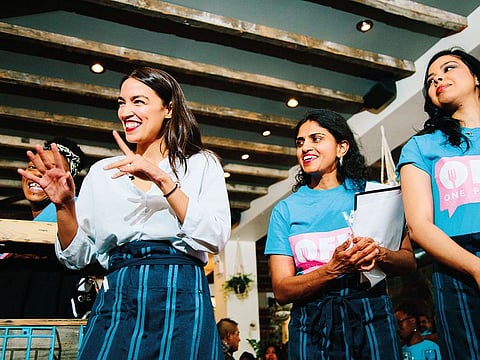 Rep. Alexandria Ocasio-Cortez (D-N.Y.), left, at The Queensboro Restaurant in Jackson Heights, New York.
