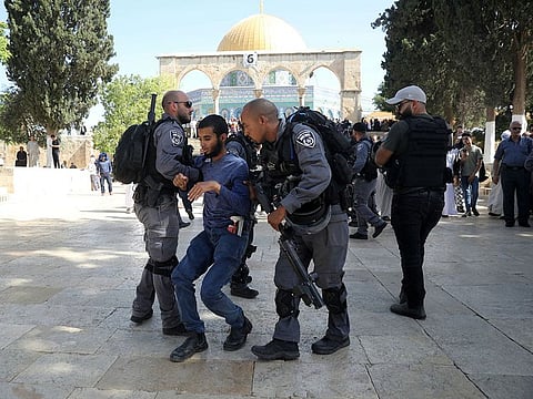 Israeli police officers detain a Palestinian man near the Dome of the Rock Mosque in the Al Aqsa Mosque compound in Jerusalem's old city, Sunday, June 2, 2019.
