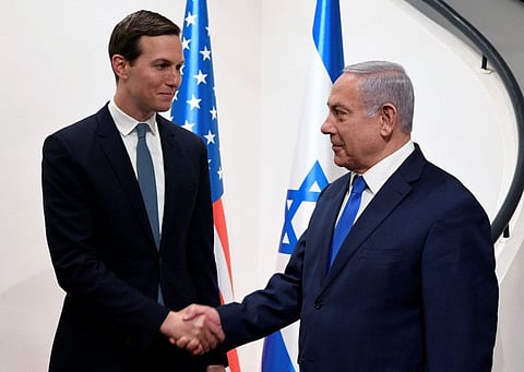 This handout picture provided by the US Embassy in Occupied Jerusalem, shows Israeli Prime Minister Banjamin Netanyahu (R) shaking hands with the US president's son-in-law and adviser Jared Kushner in the holy city on May 30, 2019.