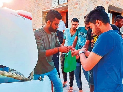 Rafeez Ahmad distributing iftar to workers.