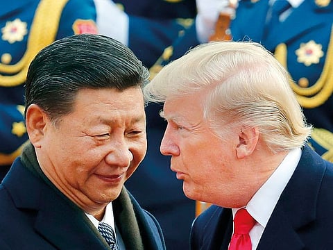 In this Nov. 9, 2017, file photo, U.S. President Donald Trump, right, chats with Chinese President Xi Jinping during a welcome ceremony at the Great Hall of the People in Beijing.