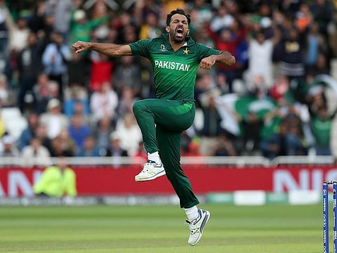 Pakistan's Wahab Riaz celebrates taking the wicket of England's Chris Woakes.