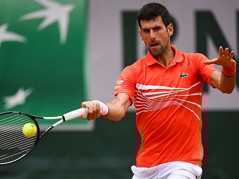 Serbia's Novak Djokovic returns the ball to Germany's Jan-Lennard Struff during their men's singles fourth round match on day nine of The Roland Garros 2019 French Open tennis tournament in Paris.