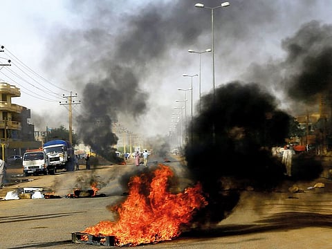 Sudanese protesters use burning tyres to erect a barricade on a street, demanding that the country’s Transitional Military Council hand over power to civilians, in Khartoum, Sudan.