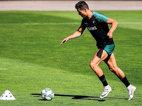 Star forward Cristiano Ronaldo controls a ball during a training session at Portugal’s “Cidade do Futebol” training camp in Oeiras in the outskirts of Lisbon.