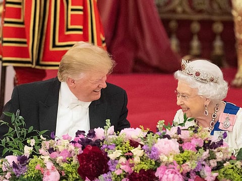 Britain's Queen Elizabeth II (R) laughs with US President Donald Trump during a State Banquet in the ballroom at Buckingham Palace in central London on June 3, 2019.