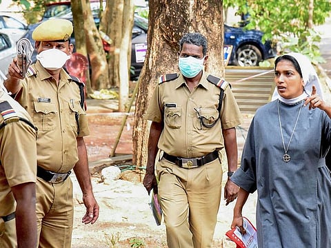 Security personnel gives instructions to a nun at Ernakulam Medical College, in Kochi.