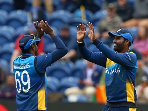 Sri Lanka's Thisara Perera celebrates (R) woth teammates after making the catch to dismiss Afghanistan's Hazratullah Zazai for 30 during the 2019 Cricket World Cup group stage match