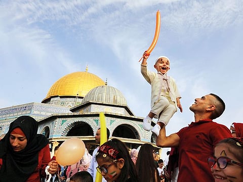 A boy smiles during Eid Al Fitr celebrations at the Al Aqsa Mosque in occupied Jerusalem’s Old City.