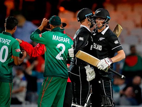 New Zealand's Mitchell Santner (R) and Lockie Ferguson celebrate victory.