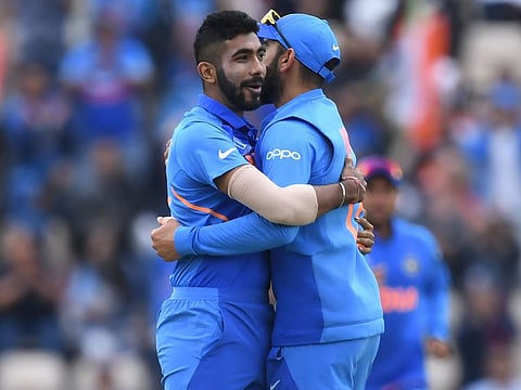 Jasprit Bumrah (left) celebrates with Virat Kohli after dismissing South Africa's Hashim Amla for six during the 2019 Cricket World Cup group stage match between South Africa and India at the Rose Bowl in Southampton, southern England.