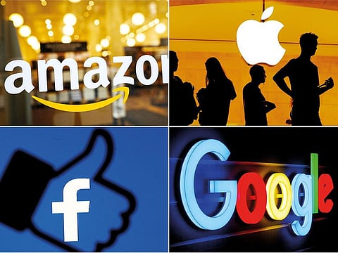 The logos of Amazon, Apple, Facebook and Google in a combination photo.