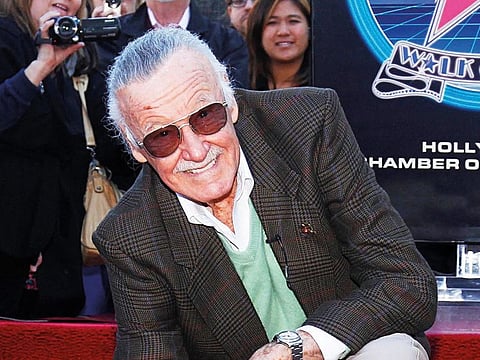 Comic book creator Stan Lee poses with his newly unveiled star on the Hollywood Walk of Fame in Hollywood, California, January 4, 2011.