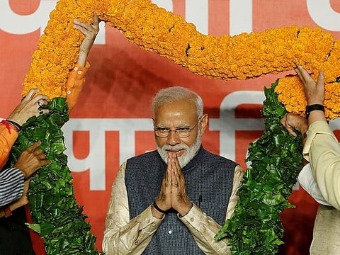Indian Prime Minister Narendra Modi gestures as he is presented with a garland by Bharatiya Janata Party (BJP) leaders after the election results in New Delhi, India, May 23, 2019.