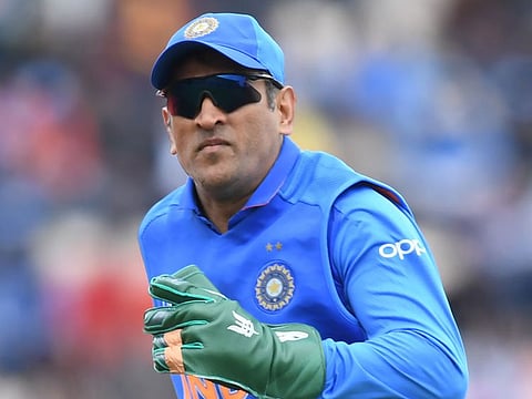 India's Mahendra Singh Dhoni fields during the 2019 Cricket World Cup group stage match between South Africa and India at the Rose Bowl in Southampton, southern England, on June 5, 2019.