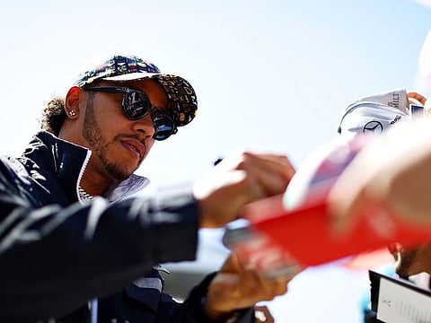Lewis Hamilton of Great Britain and Mercedes GP signs autographs for fans during previews ahead of the F1 Grand Prix of Canada at Circuit Gilles Villeneuve on June 06, 2019 in Montreal, Canada