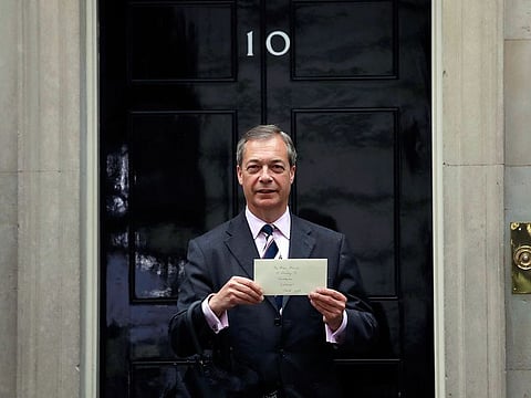 Nigel Farage the leader of Britain's Brexit Party poses for photographers before delivering a letter addressed to "The Prime Minister" asking for the Brexit Party to be included in Brexit negotiations with the European Union (EU) outside 10 Downing Street in London.