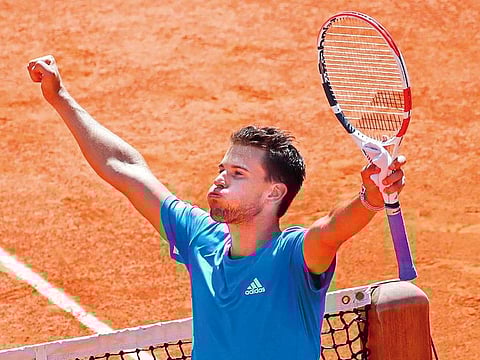 Dominic Thiem celebrates after defeating Novak Djokovic at the French Open.