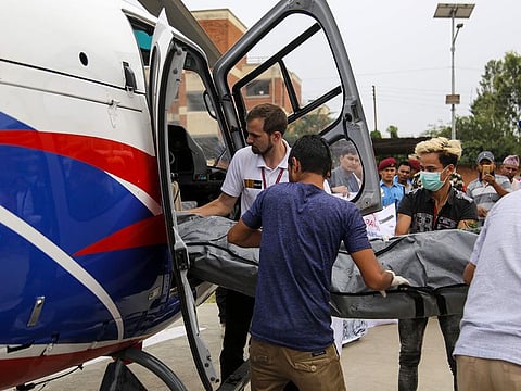 In this picture taken on 23 May, 2019, Nepali officials unload bodies of Everest climbers who died in previous seasons, at the helipad of Teaching Hospital in Kathmandu, Nepal.