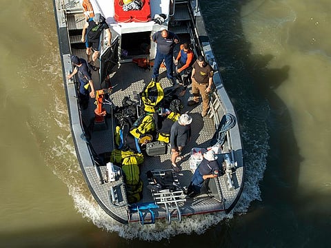 Divers work at Margaret Bridge, the scene of the deadly boat accident in Budapest, Hungary, Saturday, June 8, 2019.