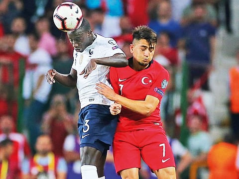 France defender Ferland Mendy (left) and Turkey’s midfielder Cengiz Under battle for the ball during the Euro 2020 Group H qualifying match in Konya on Saturday.