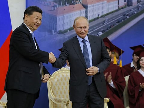 Chinese President Xi Jinping and Russian President Vladimir Putin shake hands during the ceremony to confer on Xi Jinping a degree from St. Petersburg State University at the St. Petersburg International Economic Forum on June 6, 2019.