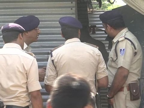 Picture of police officers investigating the case.