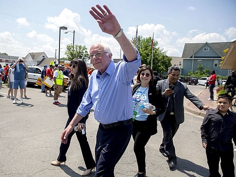 Senator Bernie Sanders, an independent from Vermont and 2020 presidential candidate, center, waves while leaving McDonald's Corp. Workers Union Action event ahead of the Iowa Democratic Party Hall of Fame event in Cedar Rapids, Iowa.