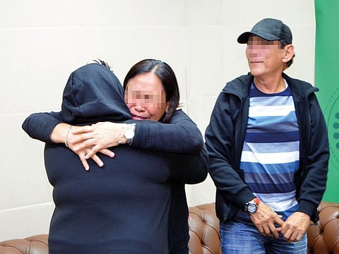 The 33-year-old Filipina with her parents. She has recovered from drug addiction and embraced Islam.