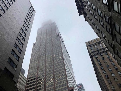 Mist and smoke cover the top of a building near 51st Street and 7th Avenue Monday, June 10, 2019, in New York, where a helicopter was reported to have crash landed on top of the roof of a building in midtown Manhattan.