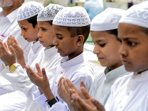 Young Indian Muslims offer prayers on the occasion of Eid al-Fitr at the Khairuddin Mosque in Amritsar on June 5, 2019. Muslims around the world are celebrating the Eid al-Fitr festival, which marks the end of the fasting month of Ramadan. / AFP / NARINDER NANU