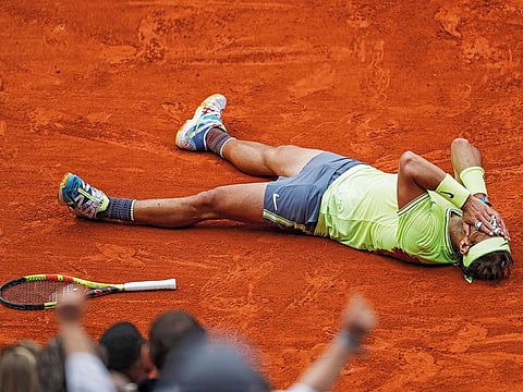 Rafael Nadal celebrates his record 12th French Open tennis tournament title after winning the final against Austria's Dominic Thiem in four sets, at the Roland Garros stadium in Paris.