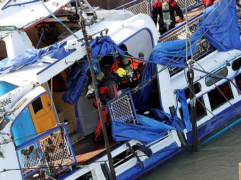 Members of a salvage crew are seen aboard The Mermaid, a Hungarian boat which sank in the Danube river near Margaret bridge, during a salvage operation in Budapest, Hungary.