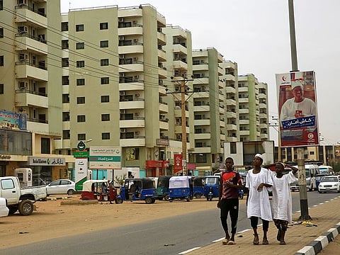 Sudanese children walk along a street in Khartoum, Sudan.
