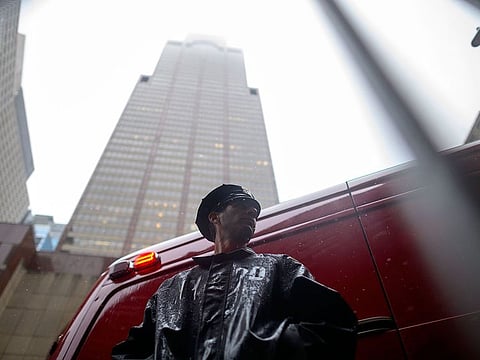 A policeman stands in front of the building where a helicopter crash-landed on top in midtown Manhattan in New York on June 10, 2019.