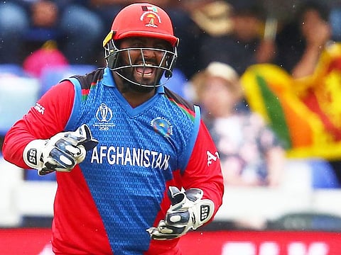 Afghanistan's Mohammad Shahzad reacts during their World Cup match against Sri Lanka.