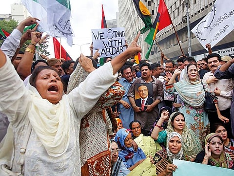 Supporters of Pakistan’s former president Asif Ali Zardari protest his arrest in Karachi.