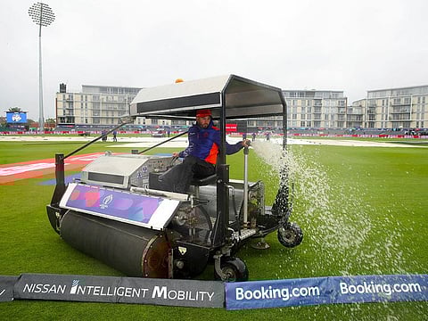 Ground staff clear water from the pitch at the ICC Cricket World Cup group stage match at the County Ground in Bristol, on Tuesday June 11, 2019.