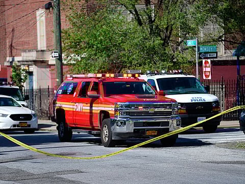 Police tape cordoned off the street along Wilcox Street behind the 121st Precinct station house following a report of a police officer shot in the Staten Island borough of New York.